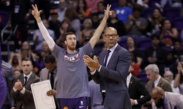 Phoenix Suns coach Monty Williams cheers on his team during the first half of an NBA basketball gam...