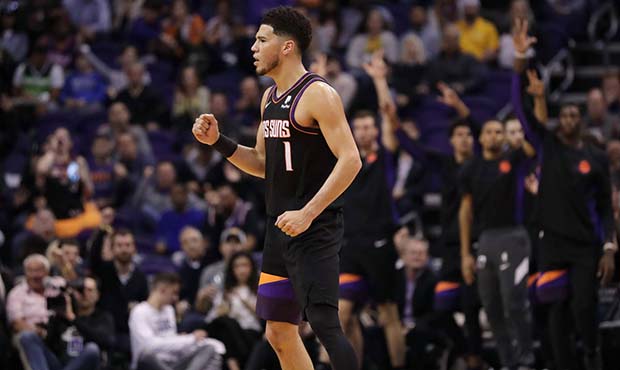 Phoenix Suns guard Devin Booker pumps his first after a basket during the second half of an NBA bas...