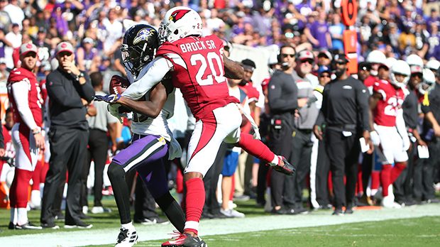 Marquise Brown #15 of the Baltimore Ravens makes a catch against Tramaine Brock #20 of the Arizona ...