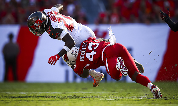 Ronald Jones #27 of the Tampa Bay Buccaneers brought down on a run by Haason Reddick #43 of the Ari...