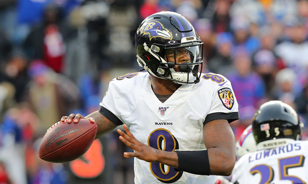 Lamar Jackson #8 of the Baltimore Ravens drops back to throw a pass against the Buffalo Bills at Ne...