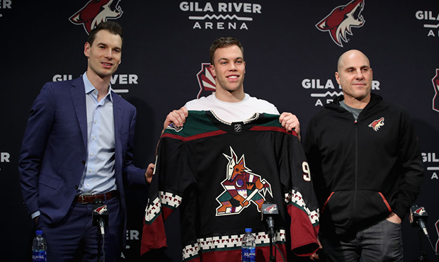 (L-R) General manager John Chayka, Taylor Hall and head coach Rick Tocchet of the Arizona Coyotes p...