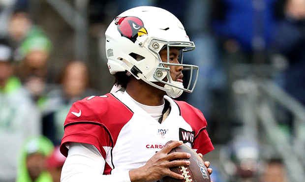 Quarterback Kyler Murray #1 of the Arizona Cardinals drops back to pass against the defense of the ...