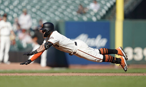 San Francisco Giants' Kevin Pillar slides into third base with a triple against the Colorado Rockie...