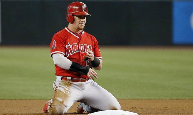 Los Angeles Angels' Kole Calhoun kneels behind second base after being forced out during the first ...