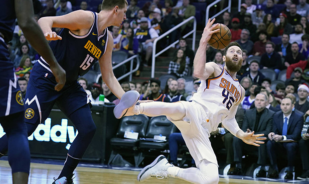 Phoenix Suns center Aron Baynes (46) gets fouled by Denver Nuggets center Nikola Jokic in the secon...
