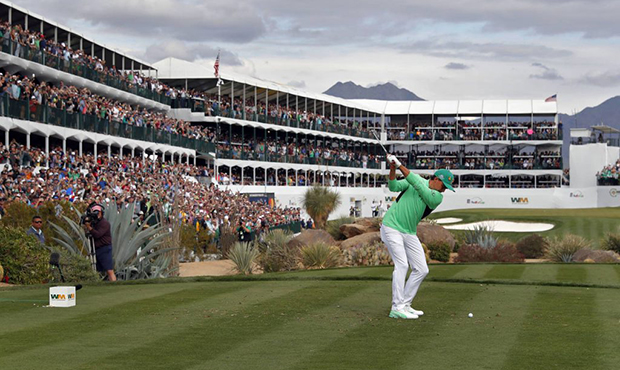 Rickie Fowler hits from the 16th tee during the third round of the Phoenix Open PGA golf tournament...