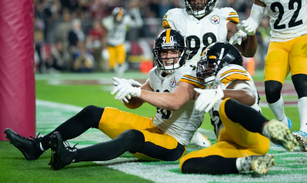 Outside linebacker T.J. Watt #90 of the Pittsburgh Steelers celebrates with teammates after an inte...