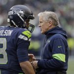 Seattle Seahawks head coach Pete Carroll, right, talks with quarterback Russell Wilson, left, during the first half of an NFL football game against the Arizona Cardinals, Sunday, Dec. 22, 2019, in Seattle. (AP Photo/Elaine Thompson)