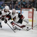 Arizona Coyotes goalie Darcy Kuemper (35) and Jordan Oesterle block a shot from San Jose Sharks' Logan Couture, right, during the first period of an NHL hockey game Tuesday, Dec. 17, 2019, in San Jose, Calif. (AP Photo/Ben Margot)
