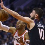 Houston Rockets guard Russell Westbrook, left, tries to control the ball as Phoenix Suns guard Ty Jerome (10) defends during the first half of an NBA basketball game Saturday, Dec. 21, 2019, in Phoenix. (AP Photo/Ross D. Franklin)