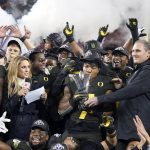 Oregon running back CJ Verdell (7) and teammates celebrate after Oregon defeated Utah 37-15 in an NCAA college football game for the Pac-12 Conference championship in Santa Clara, Calif., Friday, Dec. 6, 2018. (AP Photo/Tony Avelar)