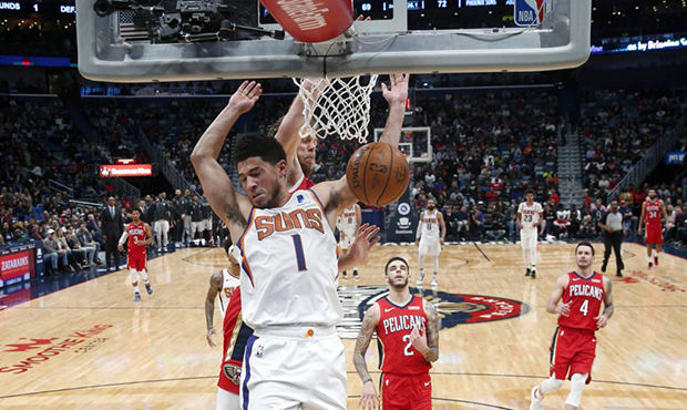 Phoenix Suns guard Devin Booker (1) dunks in front of New Orleans Pelicans forward Nicolo Melli dur...