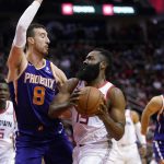 Houston Rockets' James Harden (13) goes up for a shot as Phoenix Suns' Frank Kaminsky (8) defends during the first half of an NBA basketball game Saturday, Dec. 7, 2019, in Houston. (AP Photo/David J. Phillip)