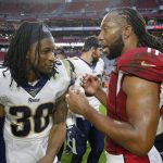 Los Angeles Rams running back Todd Gurley, left, greets Arizona Cardinals wide receiver Larry Fitzgerald after an NFL football game, Sunday, Dec. 1, 2019, in Glendale, Ariz. The Rams won 34-7. (AP Photo/Rick Scuteri)