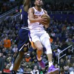 Phoenix Suns guard Devin Booker (1) drives on Denver Nuggets forward Jerami Grant in the second half during an NBA basketball game, Monday, Dec. 23, 2019, in Phoenix. The Nuggets defeated the Suns 113-111. (AP Photo/Rick Scuteri)