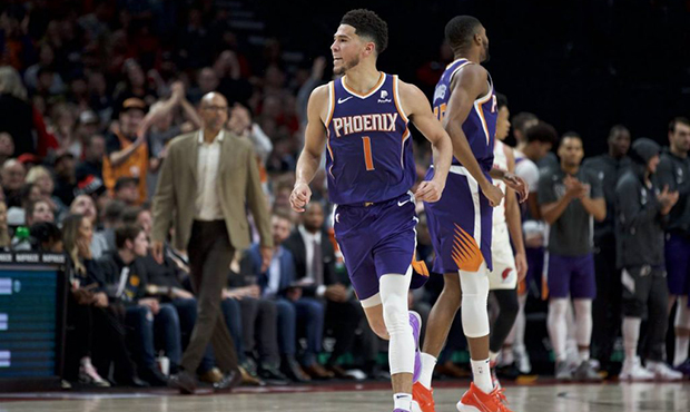 Phoenix Suns guard Devin Booker reacts after scoring against the Portland Trail Blazers during the ...