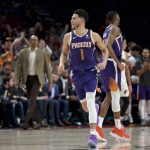 Phoenix Suns guard Devin Booker reacts after scoring against the Portland Trail Blazers during the second half of an NBA basketball game in Portland, Ore., Monday, Dec. 30, 2019. The Suns won 122-116. (AP Photo/Craig Mitchelldyer)