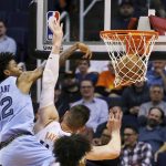 Memphis Grizzlies guard Ja Morant (12) dunks over Phoenix Suns center Aron Baynes during the second half of an NBA basketball game, Wednesday, Dec. 11, 2019, in Phoenix. The Grizzlies defeated the Suns 115-108. (AP Photo/Ross D. Franklin)