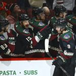 Arizona Coyotes right wing Clayton Keller (9) celebrates his goal against the Chicago Blackhawks with teammates Conor Garland (83) and Brad Richardson (15) during the second period of an NHL hockey game Thursday, Dec. 12, 2019 in Glendale, Ariz. (AP Photo/Ross D. Franklin)