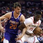 Houston Rockets' Clint Capela (15) gets tangled up with Phoenix Suns' Dario Saric (20) during the first half of an NBA basketball game Saturday, Dec. 7, 2019, in Houston. (AP Photo/David J. Phillip)