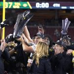 Oregon coach Mario Cristobal holds up the trophy after Oregon defeated Utah 37-15 in an NCAA college football game for the Pac-12 Conference championship in Santa Clara, Calif., Friday, Dec. 6, 2018. (AP Photo/Tony Avelar)