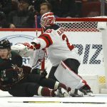 Arizona Coyotes center Christian Dvorak (18) collides with New Jersey Devils goaltender Mackenzie Blackwood during the first period of an NHL hockey game Saturday, Dec. 14, 2019 in Glendale, Ariz. (AP Photo/Ross D. Franklin)