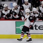 Arizona Coyotes right wing Conor Garland (83) celebrates with teammates after scoring a goal in a shootout of an NHL hockey game against the Chicago Blackhawks Sunday, Dec. 8, 2019, in Chicago. The Coyotes defeated the Blackhawks 4-3. (AP Photo/Nam Y. Huh)