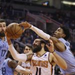 Phoenix Suns guard Ricky Rubio (11) gets fouled by Memphis Grizzlies guard Ja Morant, right, as Grizzlies center Jonas Valanciunas (17) looks on during the second half of an NBA basketball game, Wednesday, Dec. 11, 2019, in Phoenix. The Grizzlies defeated the Suns 115-108. (AP Photo/Ross D. Franklin)