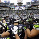 Seattle Seahawks players huddle on the field before an NFL football game against the Arizona Cardinals, Sunday, Dec. 22, 2019, in Seattle. (AP Photo/Elaine Thompson)