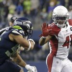 Arizona Cardinals running back Kenyan Drake fends off Seattle Seahawks linebacker Mychal Kendricks, left, as he rushes during the second half of an NFL football game, Sunday, Dec. 22, 2019, in Seattle. (AP Photo/Lindsey Wasson)