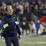 Seattle Seahawks head coach Pete Carroll throws a challenge flag near the end of an NFL football game against the Arizona Cardinals, Sunday, Dec. 22, 2019, in Seattle. (AP Photo/Elaine Thompson)