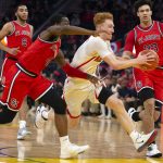 Arizona guard Nico Mannion (1) drives to the basket between St. John's guard Greg Williams Jr. (4) and forward Ian Steere (33) during the second half of an NCAA college basketball game Saturday, Dec. 21, 2019, in San Francisco. (AP Photo/D. Ross Cameron)