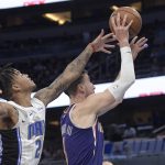 Phoenix Suns forward Frank Kaminsky (8) goes up for a shot in front of Orlando Magic guard Markelle Fultz, left, during the first half of an NBA basketball game Wednesday, Dec. 4, 2019, in Orlando, Fla. (AP Photo/Phelan M. Ebenhack)