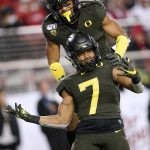 Oregon running back CJ Verdell (7) celebrates with Johnny Johnson III, top, after scoring a touchdown against Utah during the second half of an NCAA college football game for the Pac-12 Conference championship in Santa Clara, Calif., Friday, Dec. 6, 2018. Oregon won 37-15. (AP Photo/Tony Avelar)