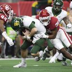 Oklahoma linebacker Nik Bonitto (35) and defensive back Brendan Radley-Hiles (44) sack Baylor quarterback Charlie Brewer during the first half of an NCAA college football game for the Big 12 Conference championship, Saturday, Dec. 7, 2019, in Arlington, Texas. (AP Photo/Jeffrey McWhorter)