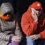 Clemson fans wait outside in the cold for the Fiesta Bowl NCAA college football game against Ohio State, Saturday, Dec. 28, 2019, in Glendale, Ariz. (AP Photo/Ross D. Franklin).