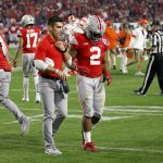 Ohio State running back J.K. Dobbins is helped off the field after being hurt during the second half of the team's Fiesta Bowl NCAA college football playoff semifinal against Clemson on Saturday, Dec. 28, 2019, in Glendale, Ariz. (AP Photo/Ross D. Franklin)