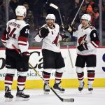 Arizona Coyotes' Phil Kessel, center, celebrates with Carl Soderberg (34) and Clayton Keller after Kessel scored an empty net goal during the third period of an NHL hockey game against the Philadelphia Flyers, Thursday, Dec. 5, 2019, in Philadelphia. The Coyotes won 3-1. (AP Photo/Derik Hamilton)