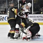 Arizona Coyotes center Christian Dvorak (18) is sandwiched between center Vegas Golden Knights Paul Stastny (26) and goaltender Marc-Andre Fleury (29) during the first period of an NHL hockey game Saturday, Dec. 28, 2019, in Las Vegas. (AP Photo/David Becker)