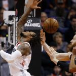 Houston Rockets guard Ben McLemore, left, loses the ball to Phoenix Suns center Aron Baynes, right, during the second half of an NBA basketball game Saturday, Dec. 21, 2019, in Phoenix. (AP Photo/Ross D. Franklin)