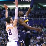 Denver Nuggets forward Jerami Grant shoots over Phoenix Suns forward Frank Kaminsky (8) in the first half during an NBA basketball game, Monday, Dec. 23, 2019, in Phoenix. (AP Photo/Rick Scuteri)