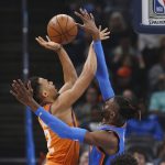 Phoenix Suns forward Elie Okobo (2) shoots as Oklahoma City Thunder center Nerlens Noel defends during the first half of an NBA basketball game Friday, Dec. 20, 2019, in Oklahoma City. (AP Photo/Sue Ogrocki)