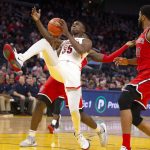 Arizona center Christian Koloko (35) is fouled by St. John's forward Marcellus Earlington, back left, during the second half of an NCAA college basketball game Saturday, Dec. 21, 2019, in San Francisco. St. John's defeated Arizona 70-67. (AP Photo/D. Ross Cameron)