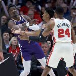 Phoenix Suns center Deandre Ayton, left, passes the ball away from Portland Trail Blazers center Hassan Whiteside during the first half of an NBA basketball game in Portland, Ore., Monday, Dec. 30, 2019. (AP Photo/Craig Mitchelldyer)