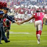 Arizona Cardinals wide receiver Larry Fitzgerald (11) greets Military personnel as he takes the field prior to an NFL football game against the Los Angeles Rams, Sunday, Dec. 1, 2019, in Glendale, Ariz. (AP Photo/Ross D. Franklin)