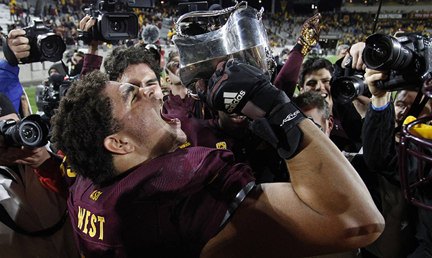 Arizona State's Dohnovan West (61) pretends to drink out of the Territorial Cup after their 24-14 w...