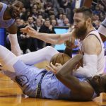 Phoenix Suns center Aron Baynes, top, battles with Memphis Grizzlies forward Jaren Jackson Jr., bottom, for a loose ball as Grizzlies forward Jae Crowder (99) looks on during the second half of an NBA basketball game, Wednesday, Dec. 11, 2019, in Phoenix. The Grizzlies defeated the Suns 115-108. (AP Photo/Ross D. Franklin)