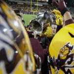 Arizona State players hold up the Territorial Cup after their 24-14 win over Arizona during their NCAA college football game Saturday, Nov. 30, 2019, in Tempe, Ariz. (AP Photo/Darryl Webb)