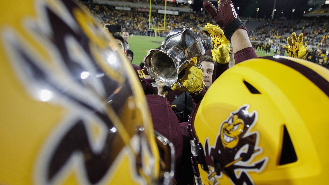 Arizona State players hold up the Territorial Cup after their 24-14 win over Arizona during their N...